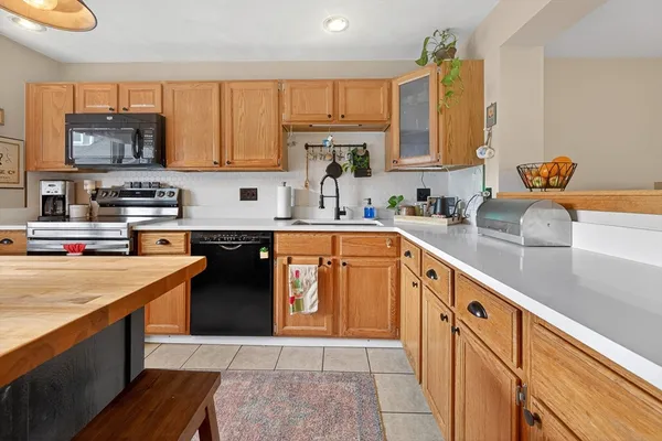 a kitchen with stainless steel appliances granite countertop a sink stove and cabinets