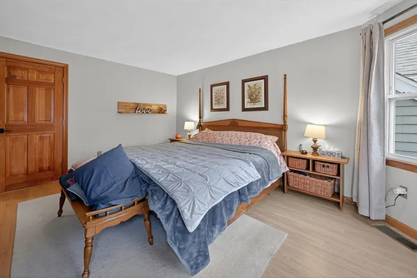 a bedroom with a bed and window