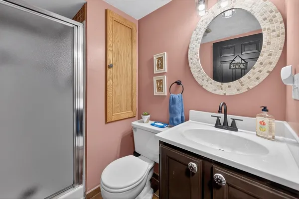 a bathroom with a toilet sink and mirror