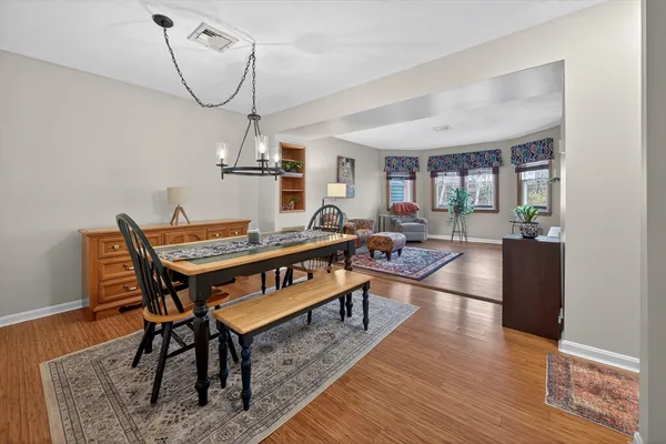 a living room with furniture a rug and a chandelier