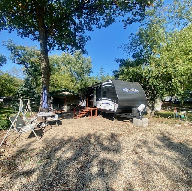 2-131 Woodhaven Sublette, IL 61367 - Photo 1 of 31 a view of backyard with a table and chairs under an umbrella