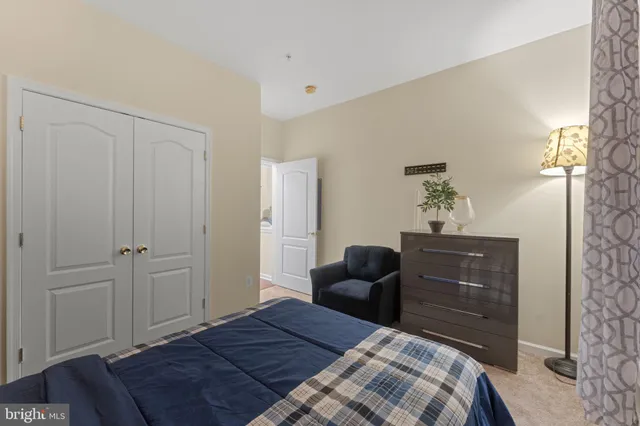 a bedroom with a bed and a mirror