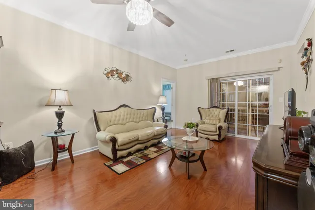 a living room with furniture a chandelier and a flat screen tv
