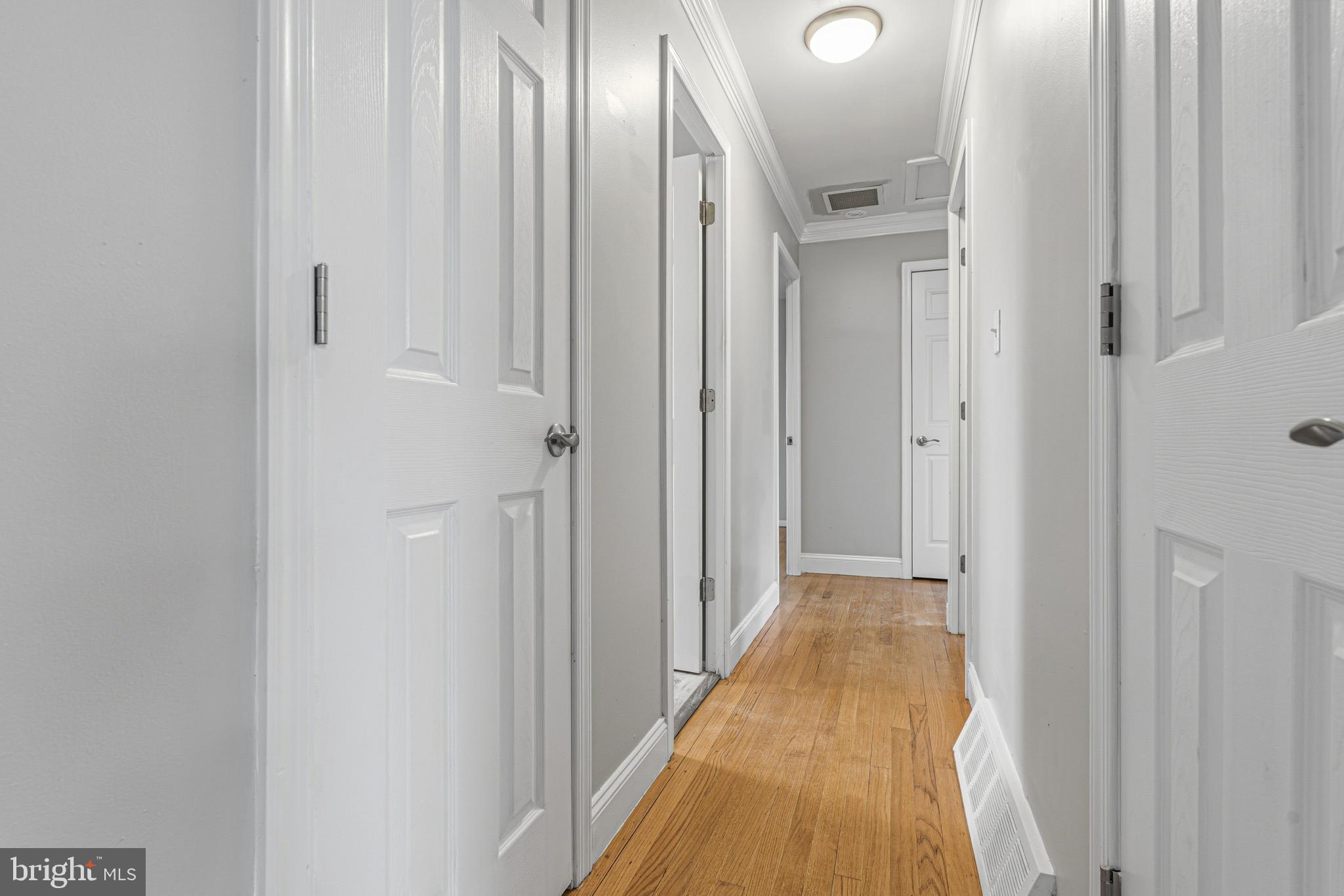 603 Tupelo Court Edgewood, MD 21040 - Photo 21 of 40 a view of a hallway with wooden floor and a bathroom
