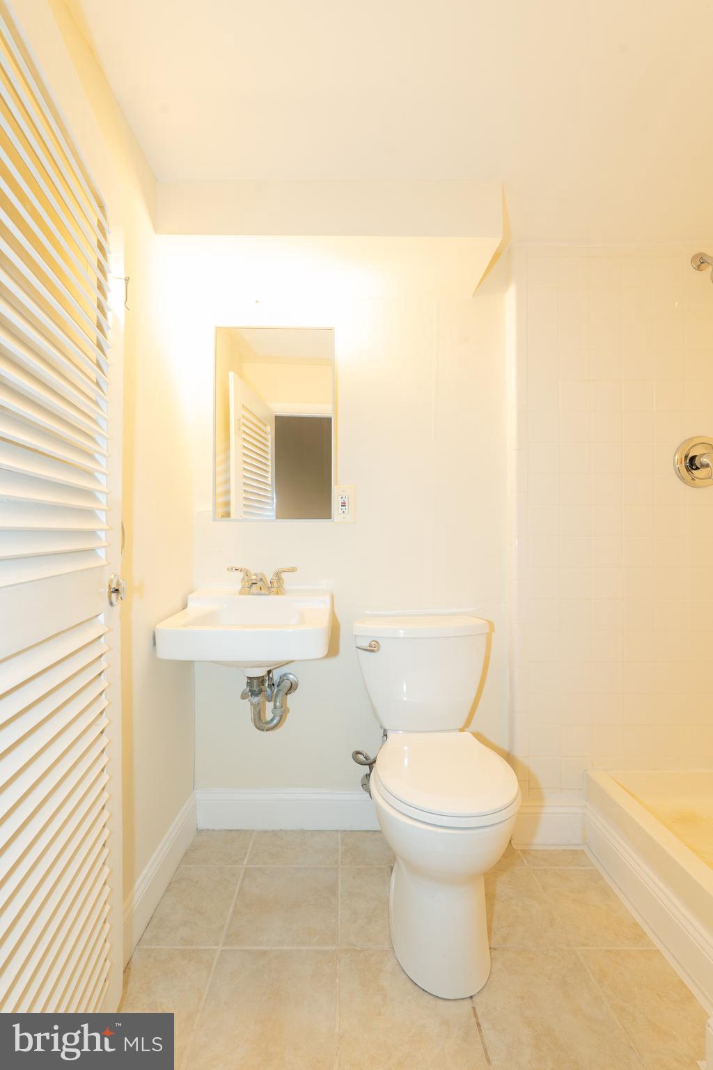 603 Tupelo Court Edgewood, MD 21040 - Photo 37 of 40 a bathroom with a sink a toilet and mirror