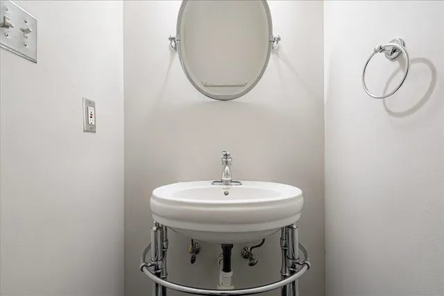 a bathroom with a sink a mirror and a toilet