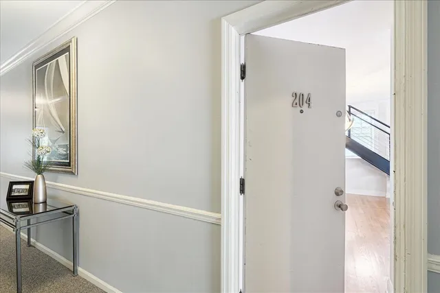 a view of an entryway with wooden floor