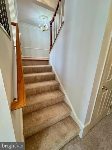 a view of staircase with white walls and a window