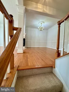 a bathroom with a bathtub and a chandelier