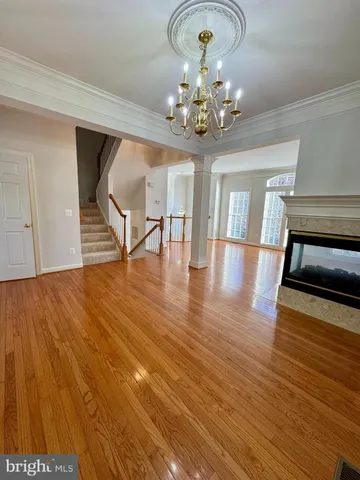 a view of a dining room with furniture wooden floor and chandelier