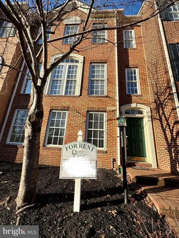 a front view of a residential apartment building with a yard