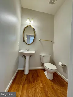 a bathroom with a toilet and a mirror