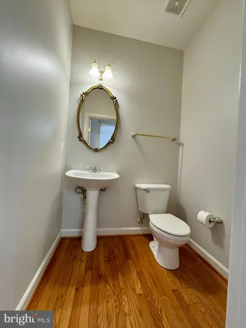 a bathroom with a toilet and a mirror