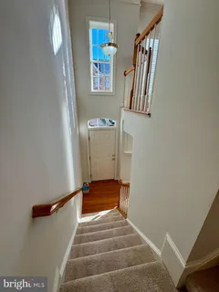 a view of staircase with white walls