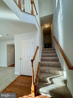 a view of staircase with wooden floor and stairs
