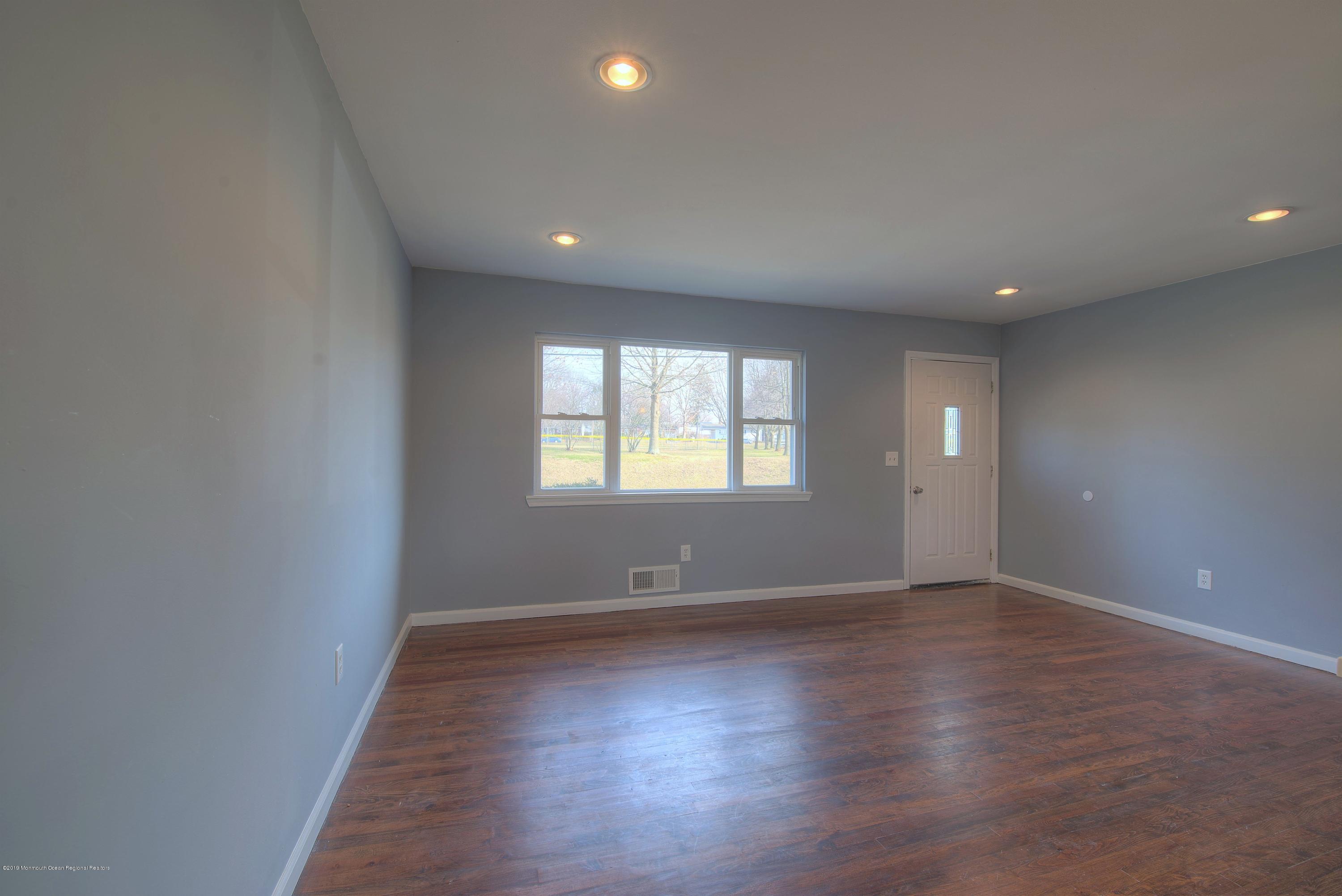48 Mallard Road Bayville, NJ 08721 - Photo 3 of 25 an empty room with wooden floor and windows