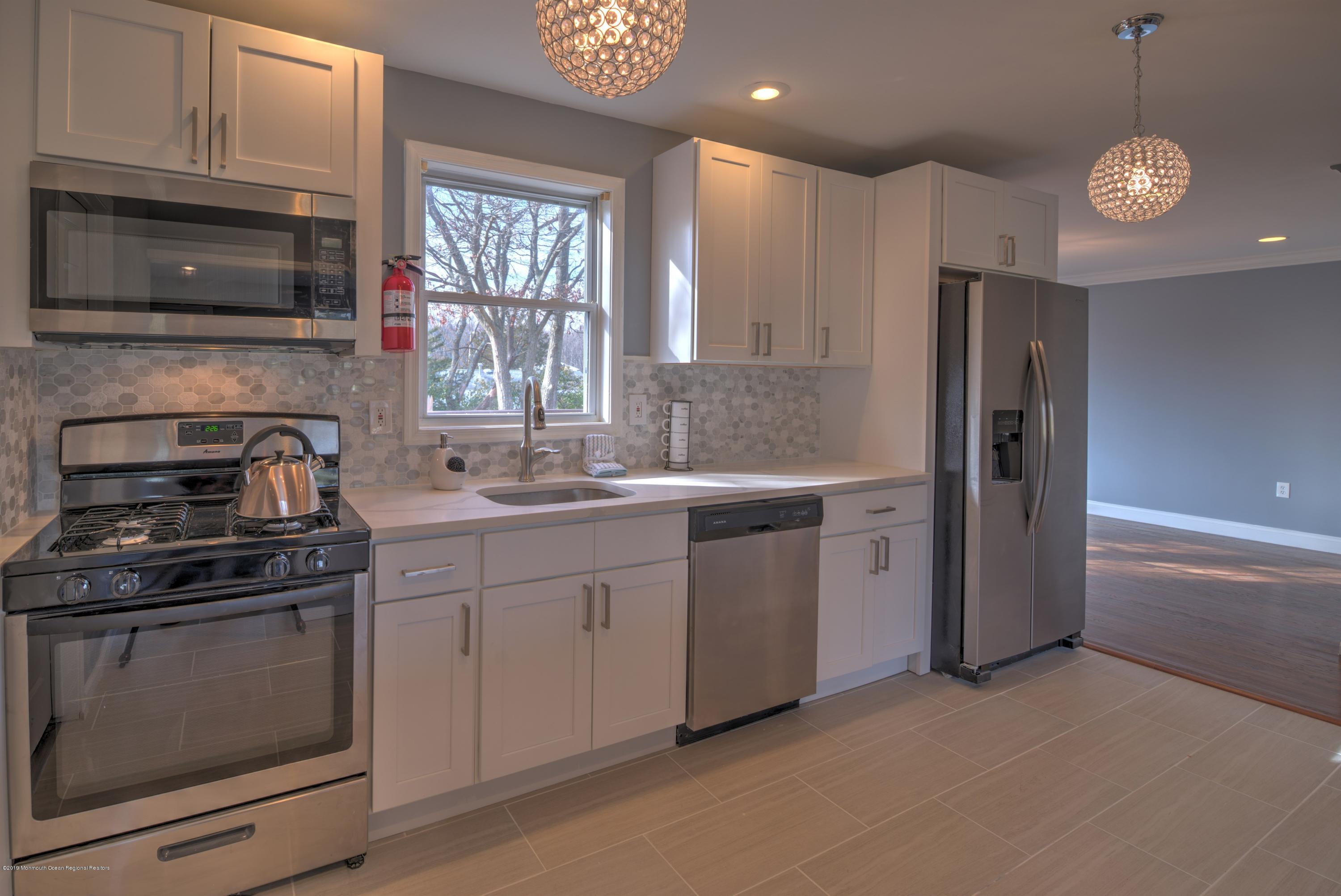 48 Mallard Road Bayville, NJ 08721 - Photo 8 of 25 a kitchen with a sink stove and microwave