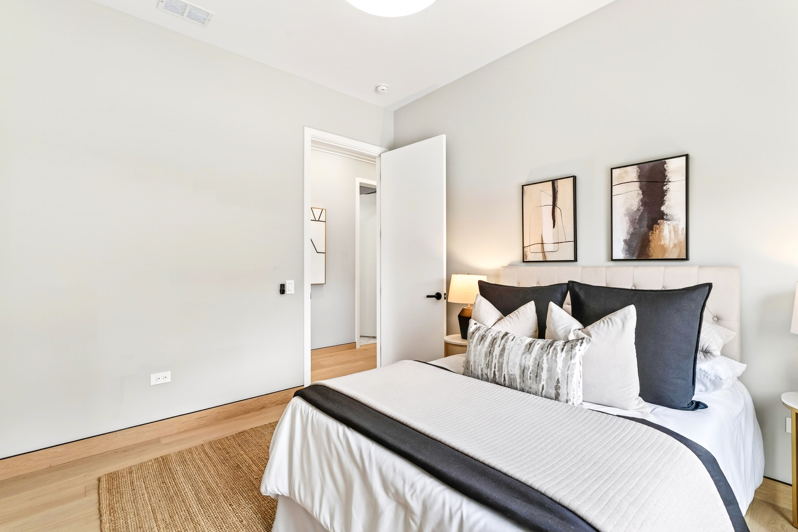 2024 West Irving Park Road, Unit 302 Chicago, IL 60618 - Photo 20 of 32 a bedroom with a bed and painting on the wall