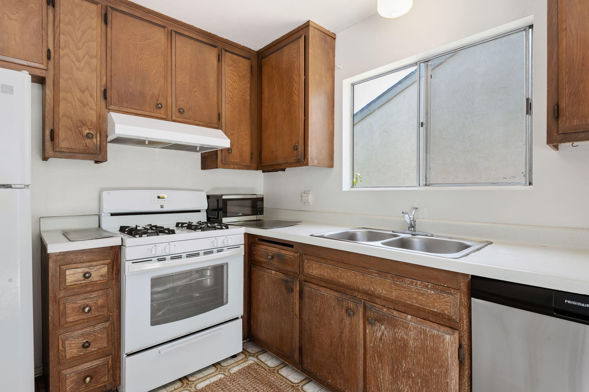 7304 Elmhurst Place Goleta, CA 93117 - Photo 9 of 20 a kitchen with a stove sink and cabinets