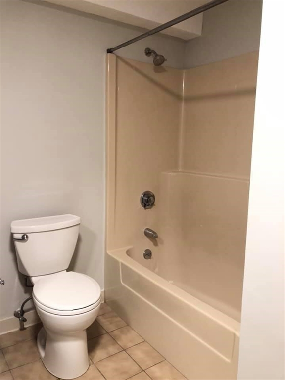 39 Parlin Street, Unit 203 Everett, MA 02149 - Photo 11 of 20 a bathroom with a toilet and shower