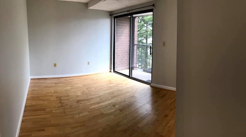 39 Parlin Street, Unit 203 Everett, MA 02149 - Photo 12 of 20 a view of an empty room with wooden floor and a window
