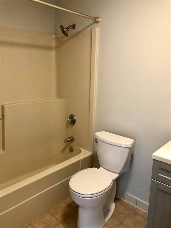 39 Parlin Street, Unit 203 Everett, MA 02149 - Photo 16 of 20 a white toilet sitting next to a bath tub and a shower