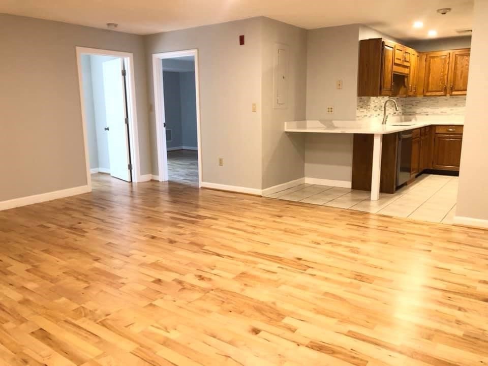 39 Parlin Street, Unit 203 Everett, MA 02149 - Photo 3 of 20 a view of kitchen with granite countertop cabinets and wooden floor