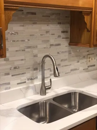 a kitchen with a sink and granite counter tops