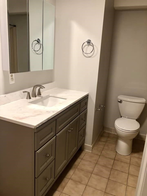 39 Parlin Street, Unit 203 Everett, MA 02149 - Photo 10 of 20 a bathroom with a toilet sink and mirror