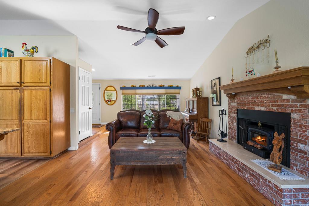 13995 Whispering Meadows Lane Jamul, CA 91935 - Photo 12 of 62 a living room with furniture a fireplace and a table