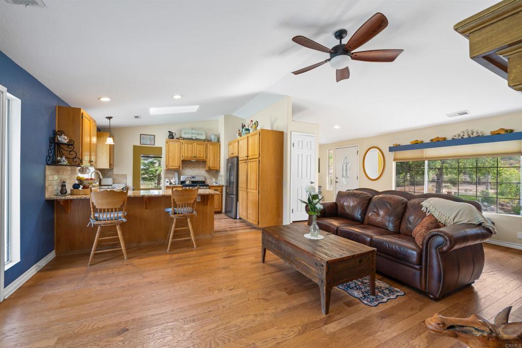 13995 Whispering Meadows Lane Jamul, CA 91935 - Photo 13 of 62 a living room with furniture ceiling fan and a rug