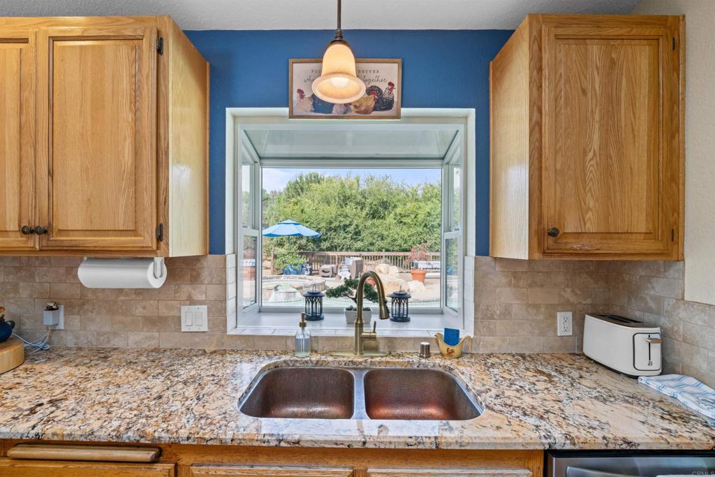13995 Whispering Meadows Lane Jamul, CA 91935 - Photo 16 of 62 a kitchen with sink a window and cabinets