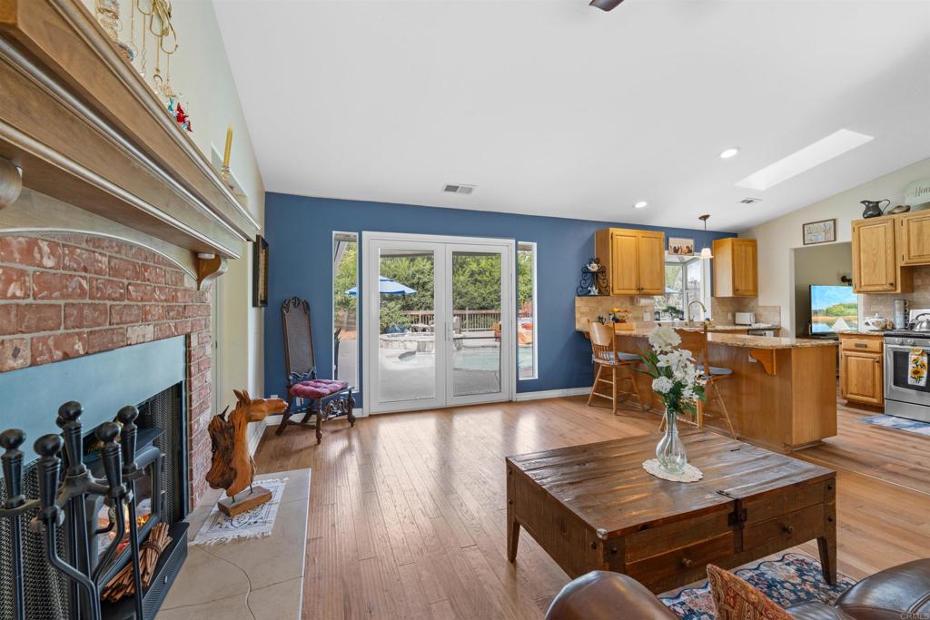 13995 Whispering Meadows Lane Jamul, CA 91935 - Photo 20 of 62 a living room with furniture flat screen tv and a fireplace