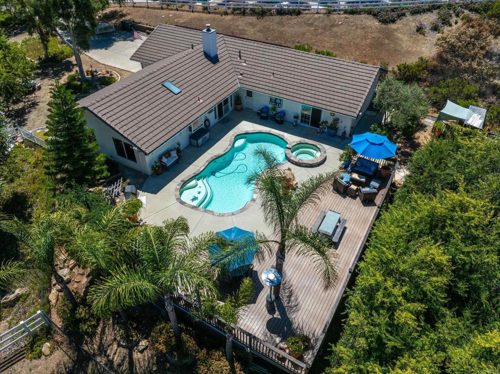 13995 Whispering Meadows Lane Jamul, CA 91935 - Photo 2 of 62 an aerial view of a house with a swimming pool and outdoor seating