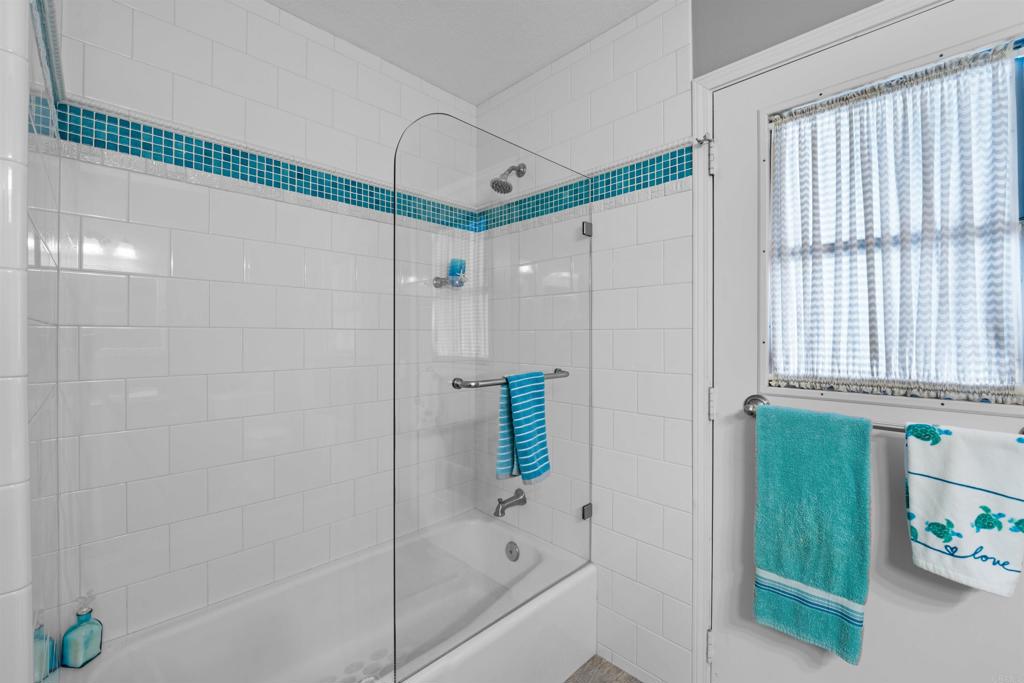 13995 Whispering Meadows Lane Jamul, CA 91935 - Photo 25 of 62 a bathroom with a shower and a bathtub