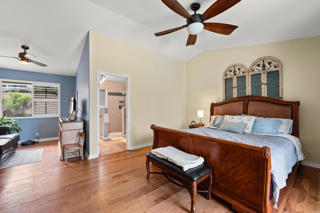 13995 Whispering Meadows Lane Jamul, CA 91935 - Photo 31 of 62 a bedroom with a bed and wooden floor