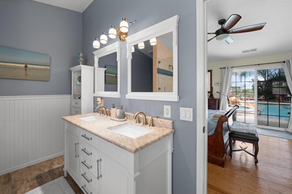 13995 Whispering Meadows Lane Jamul, CA 91935 - Photo 33 of 62 a bathroom with a sink vanity and mirror
