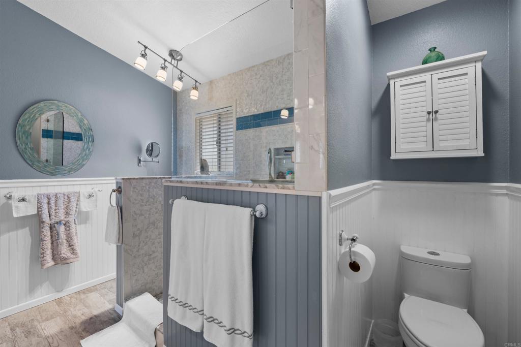 13995 Whispering Meadows Lane Jamul, CA 91935 - Photo 36 of 62 a bathroom with a toilet a sink and mirror