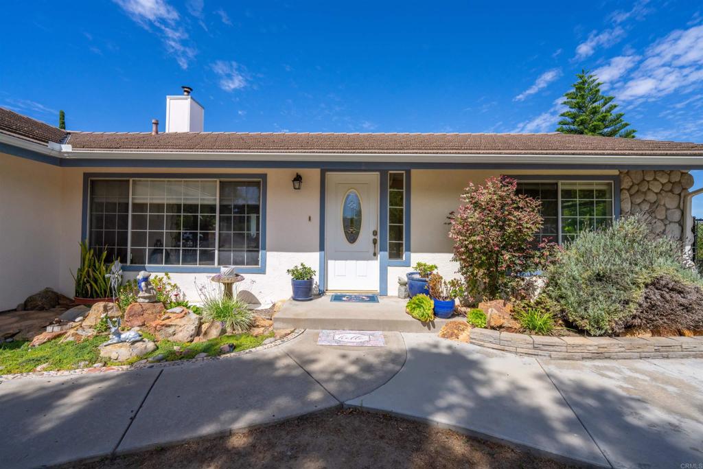 13995 Whispering Meadows Lane Jamul, CA 91935 - Photo 41 of 62 a front view of a house with a yard
