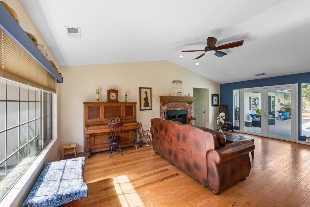 13995 Whispering Meadows Lane Jamul, CA 91935 - Photo 10 of 62 a living room with furniture and a fireplace