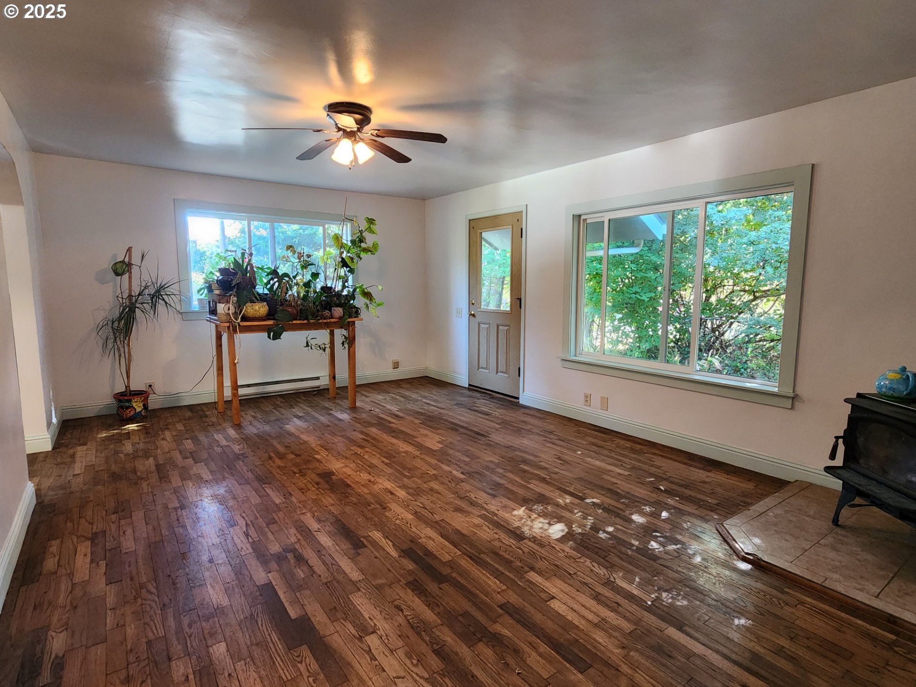 636 18th Street Port Orford, OR 97465 - Photo 11 of 29 a view of a livingroom with a hardwood floor and a ceiling fan