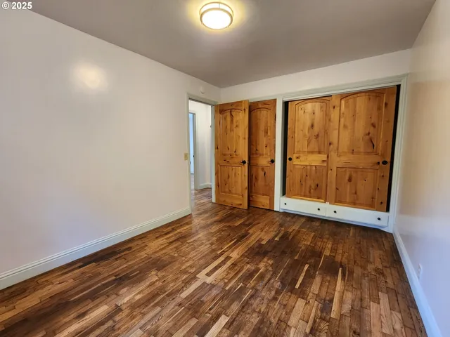 a view of closet with wooden floor