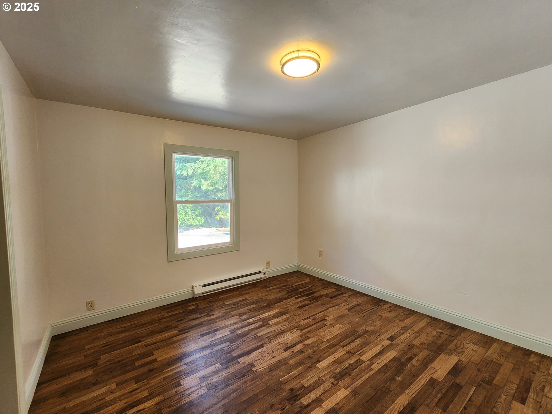 636 18th Street Port Orford, OR 97465 - Photo 17 of 29 an empty room with wooden floor and windows