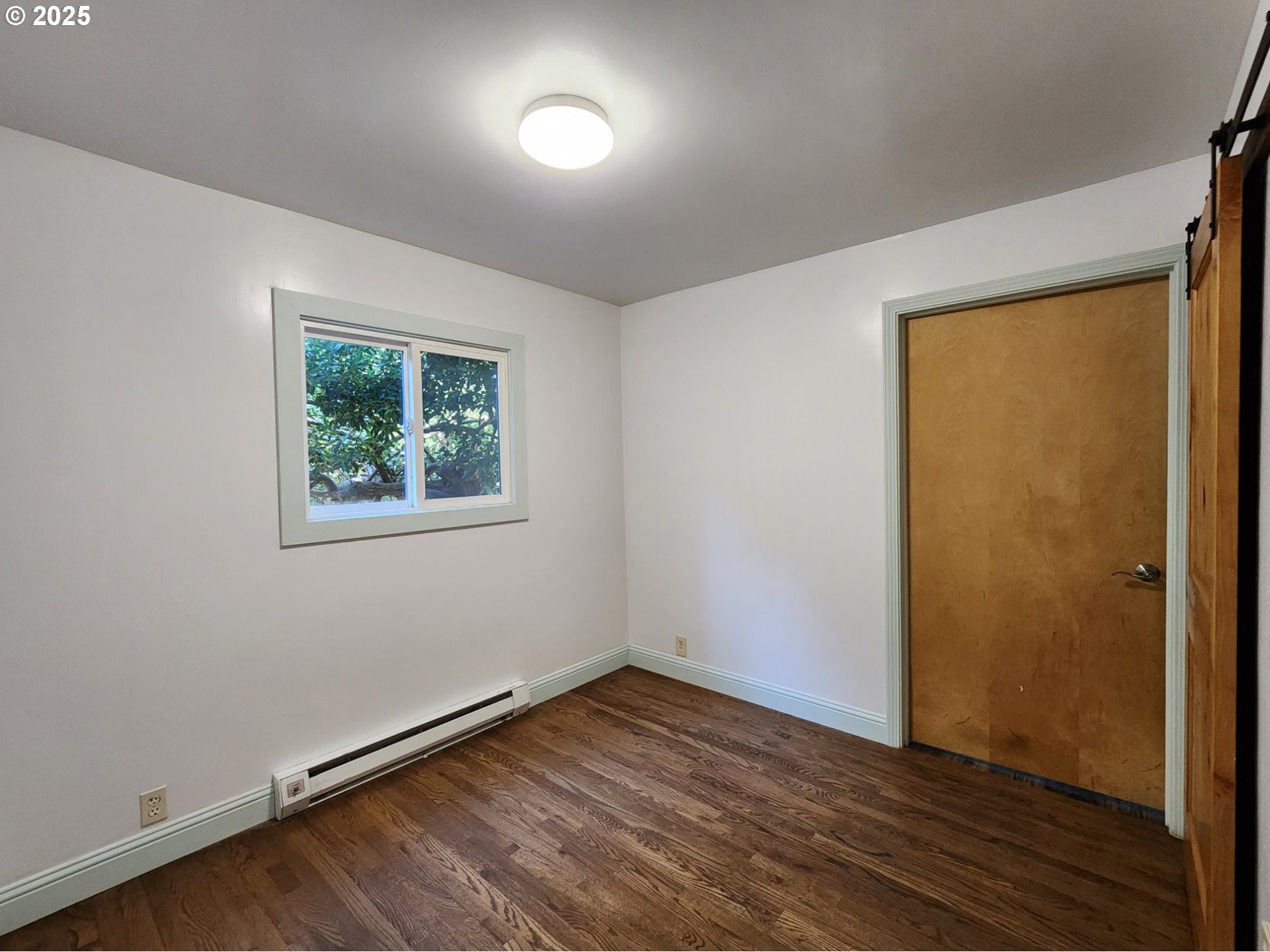 636 18th Street Port Orford, OR 97465 - Photo 20 of 29 an empty room with wooden floor and windows