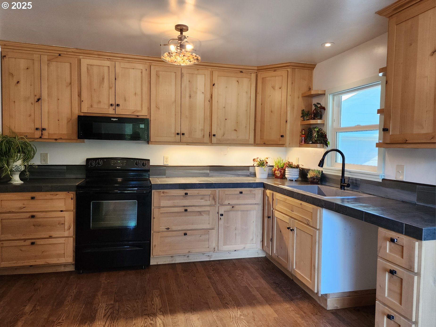 636 18th Street Port Orford, OR 97465 - Photo 6 of 29 a kitchen with granite countertop wooden cabinets and a stove
