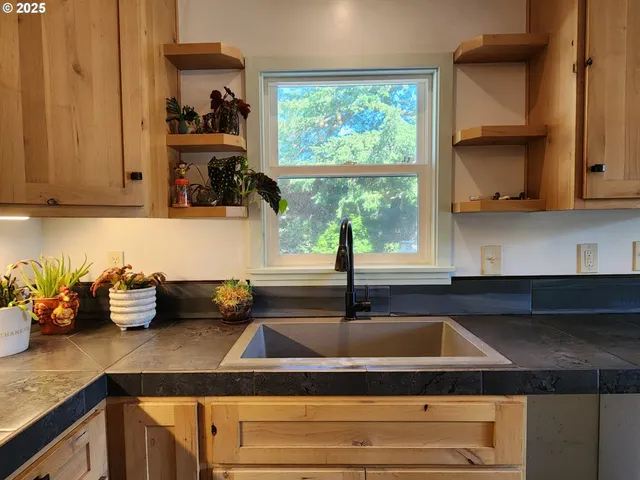 a kitchen with granite countertop a refrigerator a stove a microwave and cabinets