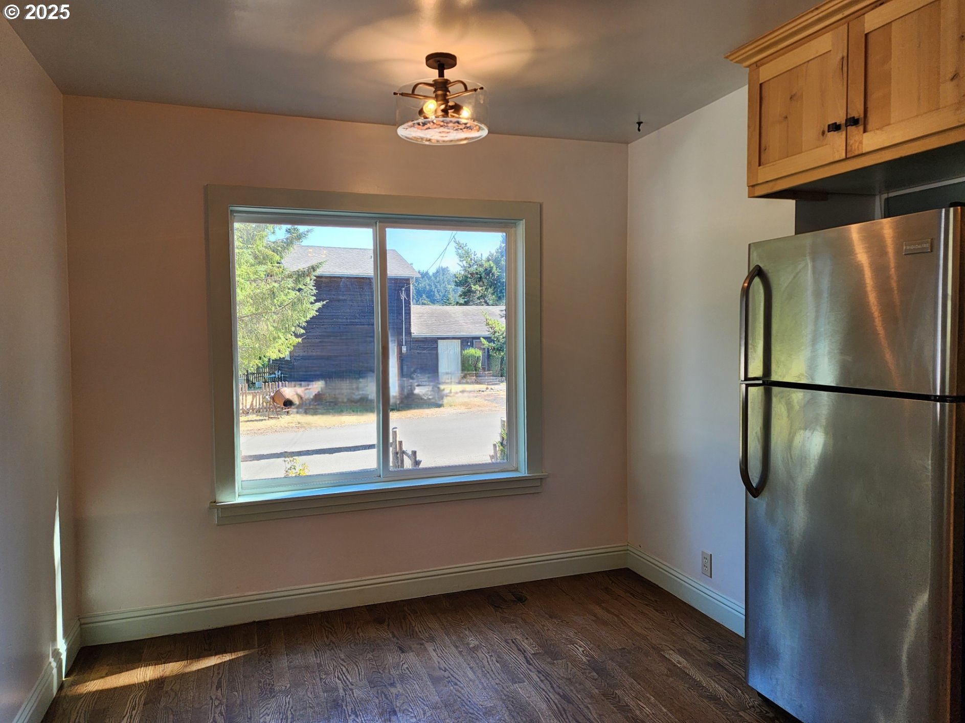 636 18th Street Port Orford, OR 97465 - Photo 10 of 29 a view of a kitchen with a fridge wooden floor cabinet and a window