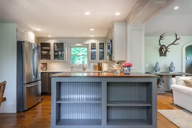 a kitchen with granite countertop a refrigerator and stove