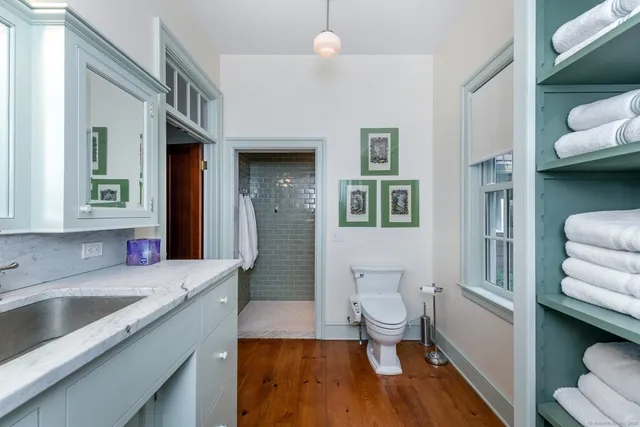 a bathroom with a sink a toilet and a shower