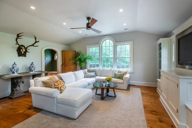 a living room with furniture fireplace and window